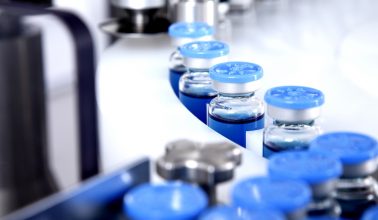 Glass bottles in production in the tray of an automatic liquid dispenser, a line for filling medicines against bacteria and viruses, antibiotics and vaccines