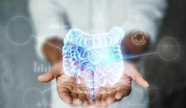 Doctor and holographic bowel scan projection with vital signs and medical records. Concept of new technologies, body scan, digital x-ray, abdominal organs, modern medicine