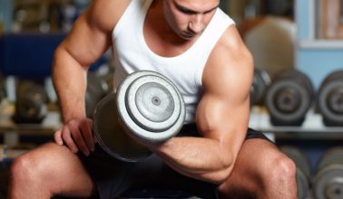 A muscular young man working out in the gym